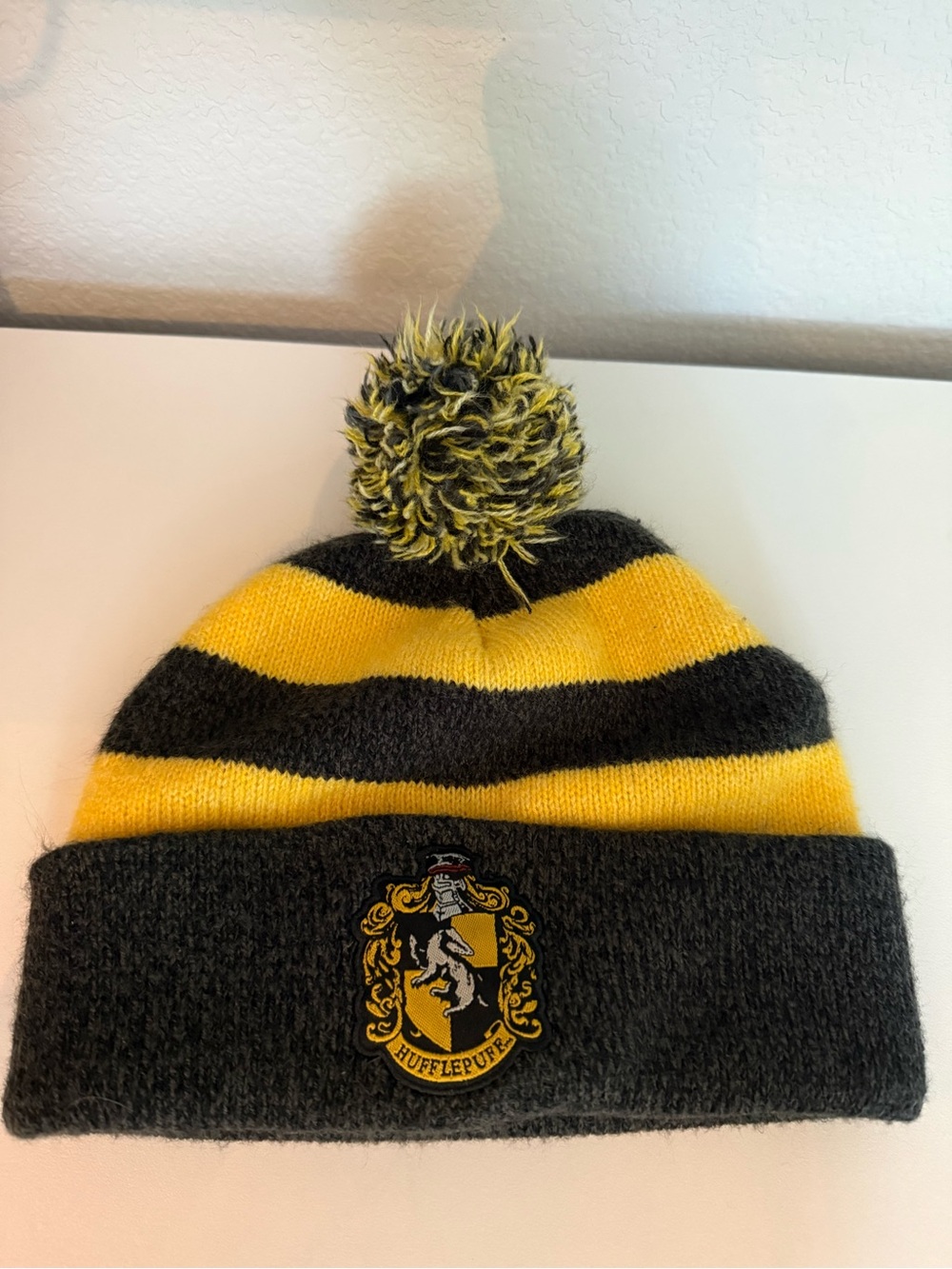Kids Yellow & Black Striped Knit Pom Beanie with Harry Potter Hufflepuff Crest